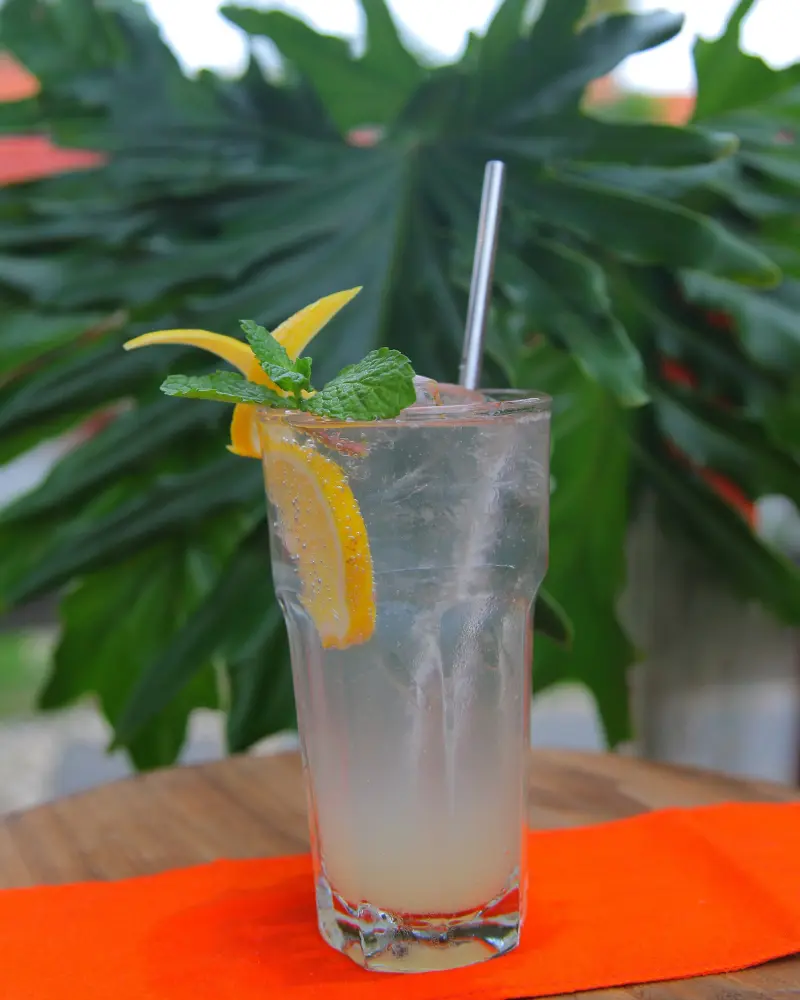 Two Morlinka scented wax tablets hanging from a wooden hanger against a soft fabric background, showcasing elegant and minimal branding.